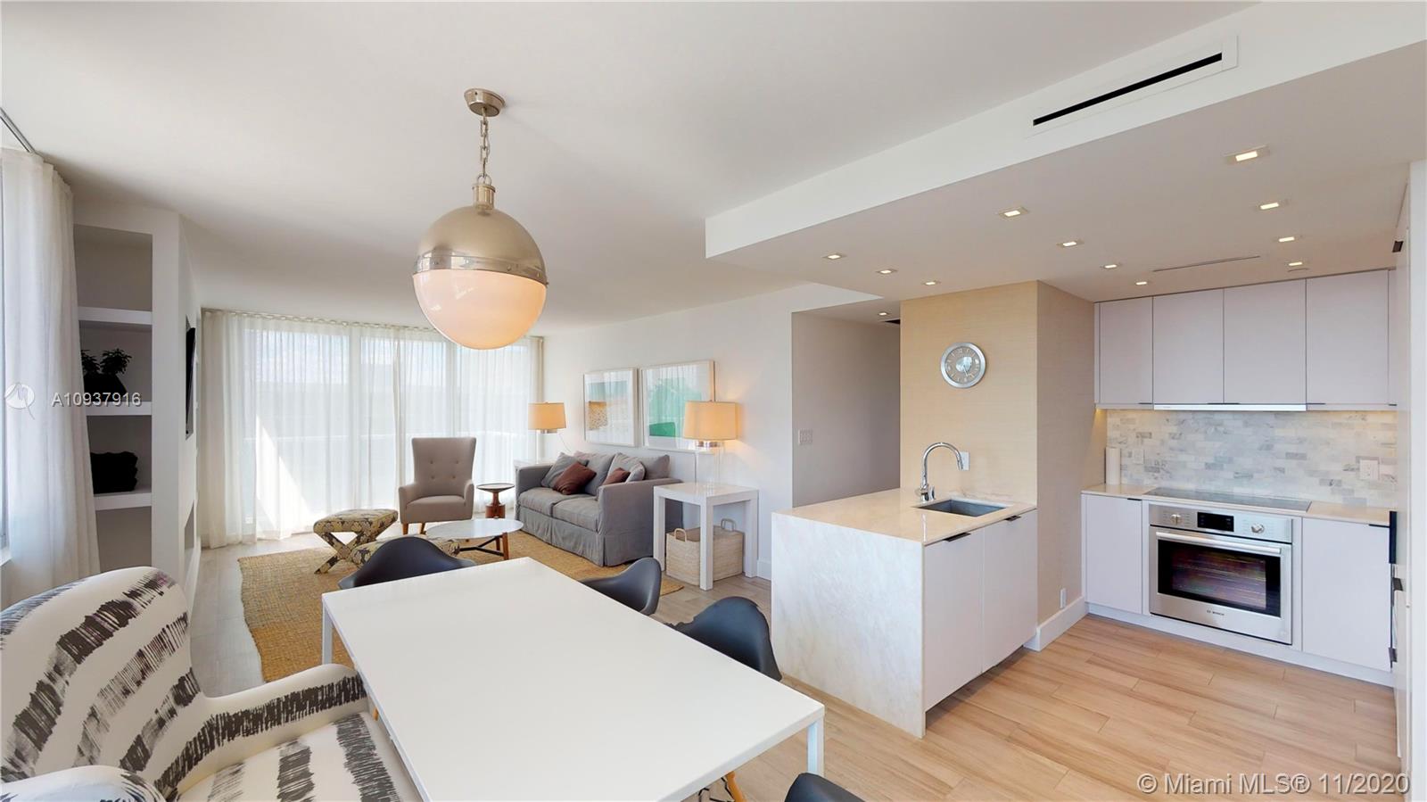 West Avenue Miami Beach, FL 33139 - Photo 7 of 29 a living room with furniture a fireplace and a chandelier