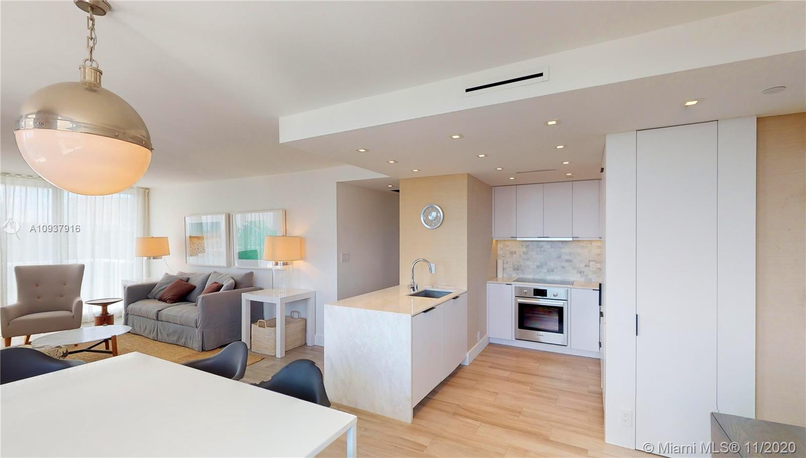 West Avenue Miami Beach, FL 33139 - Photo 10 of 29 a living room with furniture a fireplace and a table