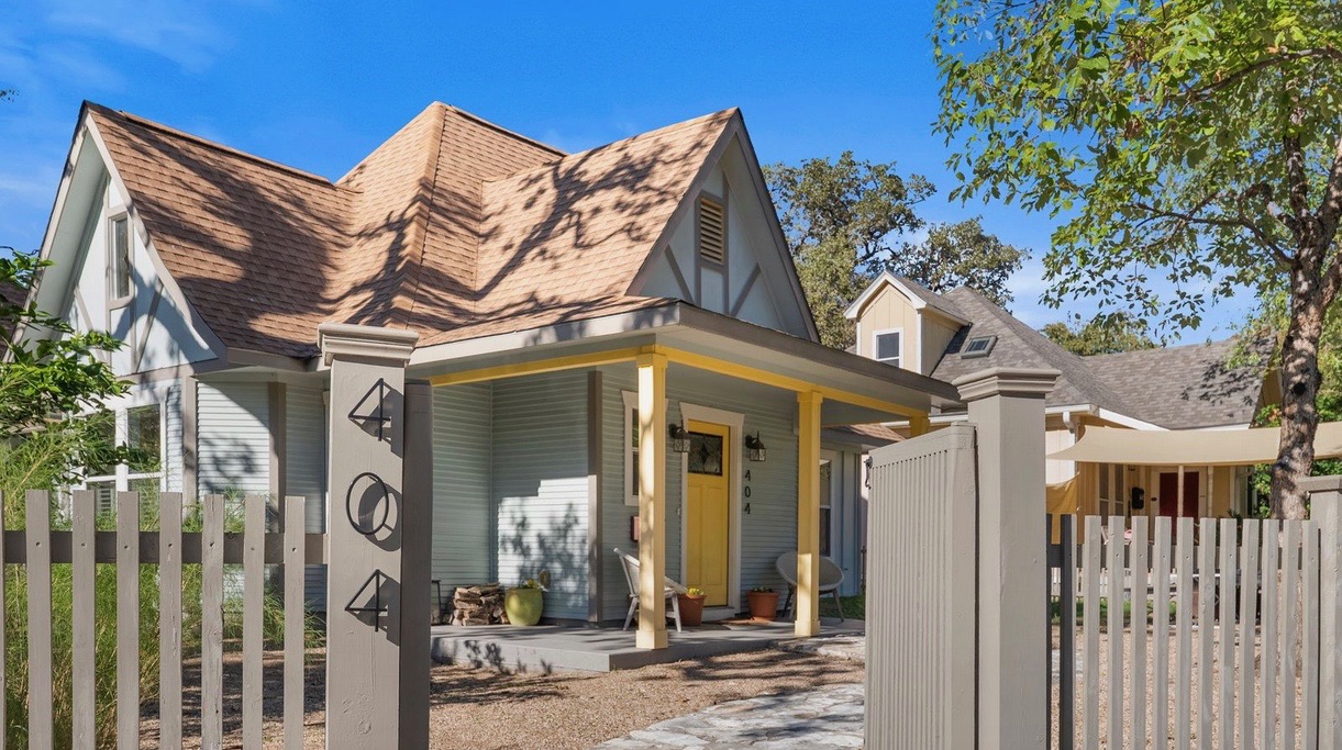 View of front of home with a porch and roof with shingles