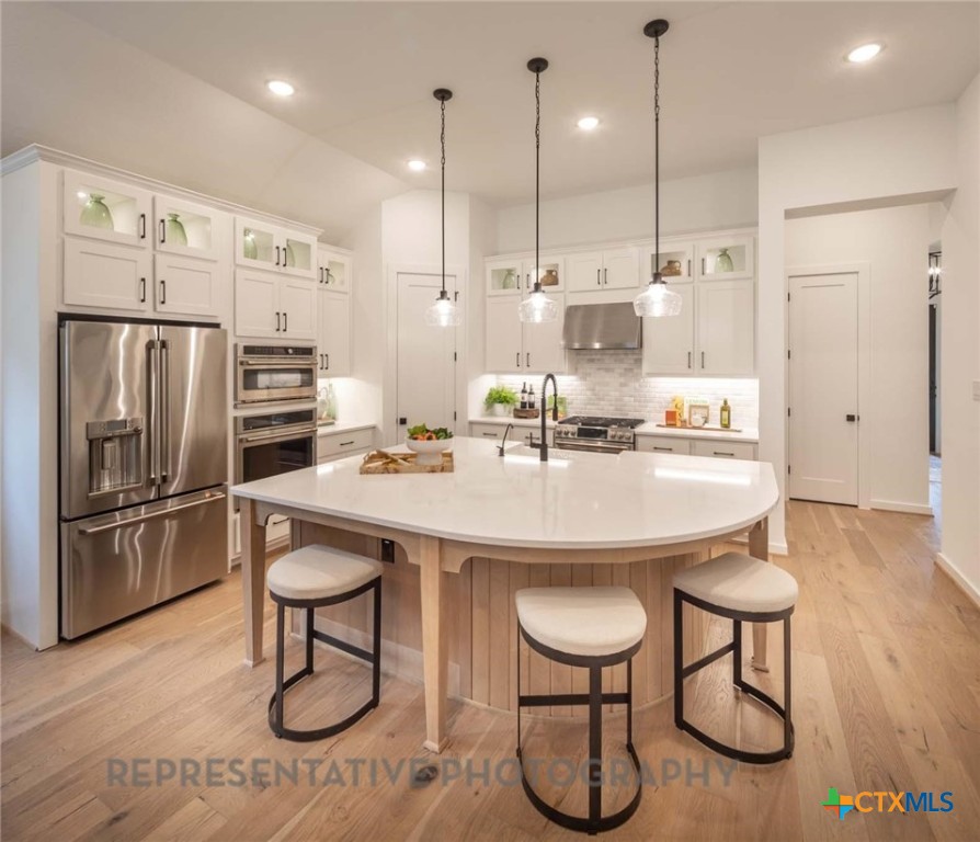 620 High Summit Drive Georgetown, TX 78628 - Photo 2 of 28 a kitchen with stainless steel appliances granite countertop a sink and a refrigerator