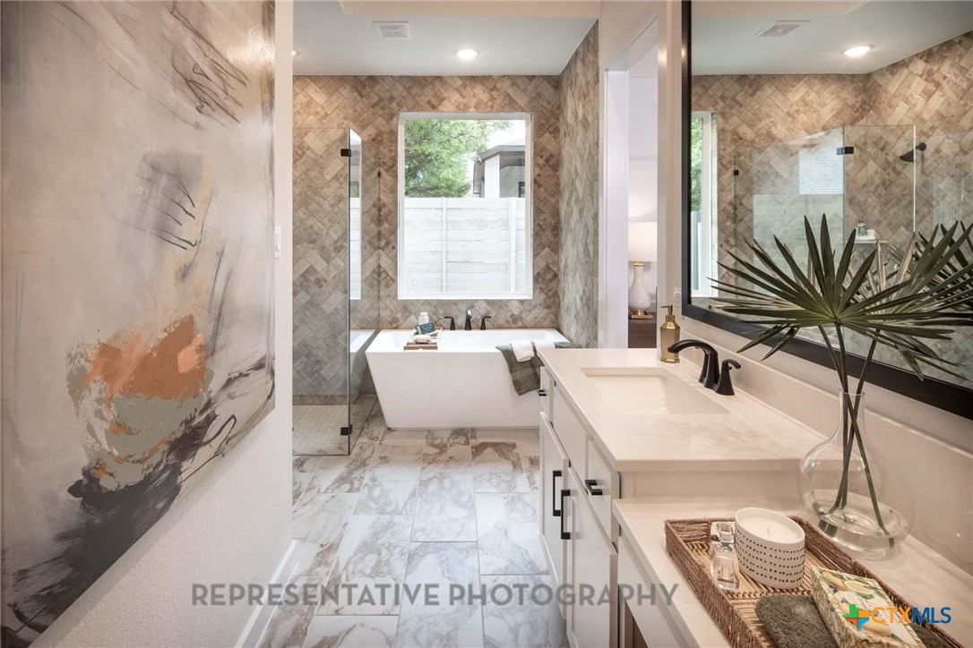 620 High Summit Drive Georgetown, TX 78628 - Photo 27 of 28 a spacious bathroom with a bathtub and sink