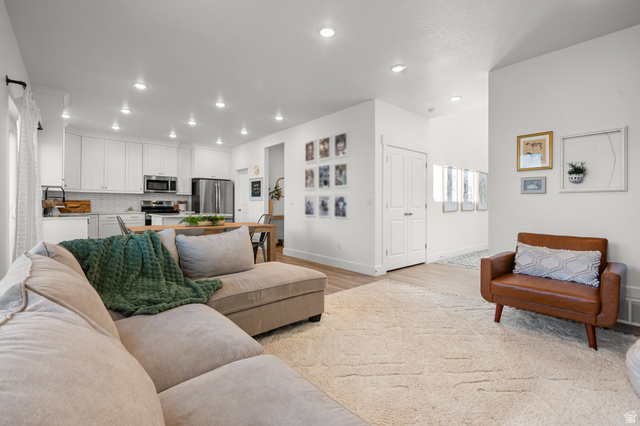 2706 West Maple Street, Unit 285 Mapleton, UT 84664 - Photo 9 of 36 Open-concept living space featuring recessed lighting, light wood-finish flooring, and a contemporary kitchen