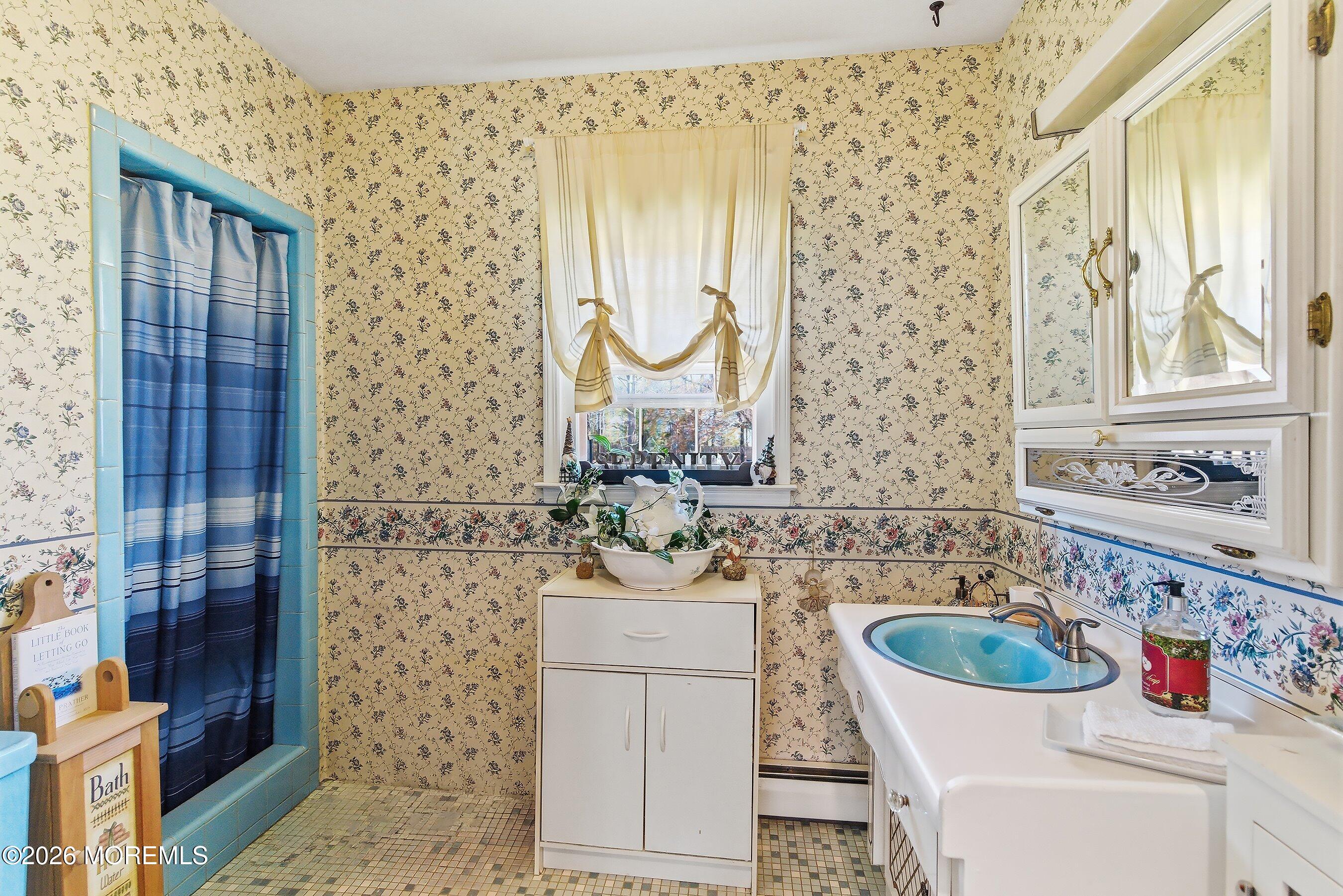 745 Oak Glen Road Howell, NJ 07731 - Photo 23 of 46 a bathroom with a sink a toilet and shower curtain