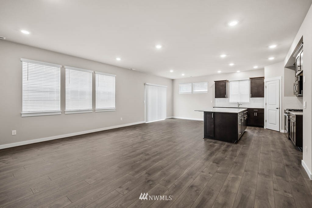 9 181st Street Southeast, Unit 16 Bothell, WA 98012 - Photo 8 of 31 a large kitchen with stainless steel appliances granite countertop a large counter top and a stove top oven