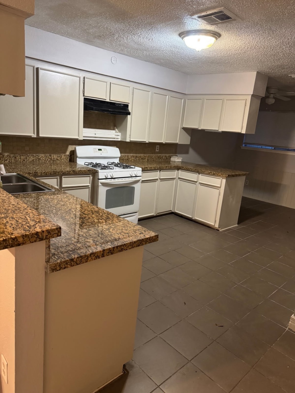 9537 Braeburn Glen Boulevard Houston, TX 77074 - Photo 14 of 15 a kitchen with stainless steel appliances granite countertop a sink and a stove