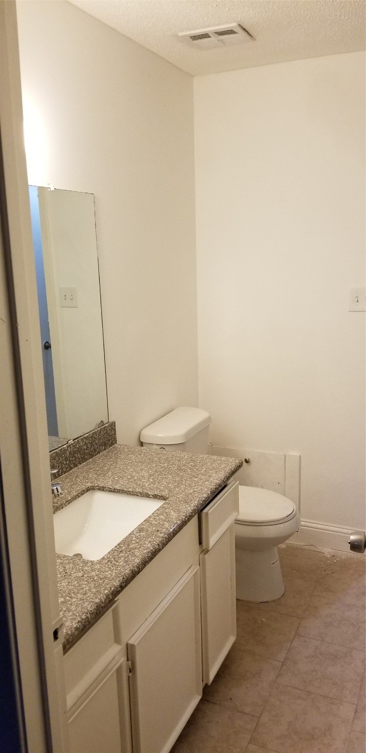9537 Braeburn Glen Boulevard Houston, TX 77074 - Photo 2 of 15 a bathroom with a granite countertop sink and a mirror