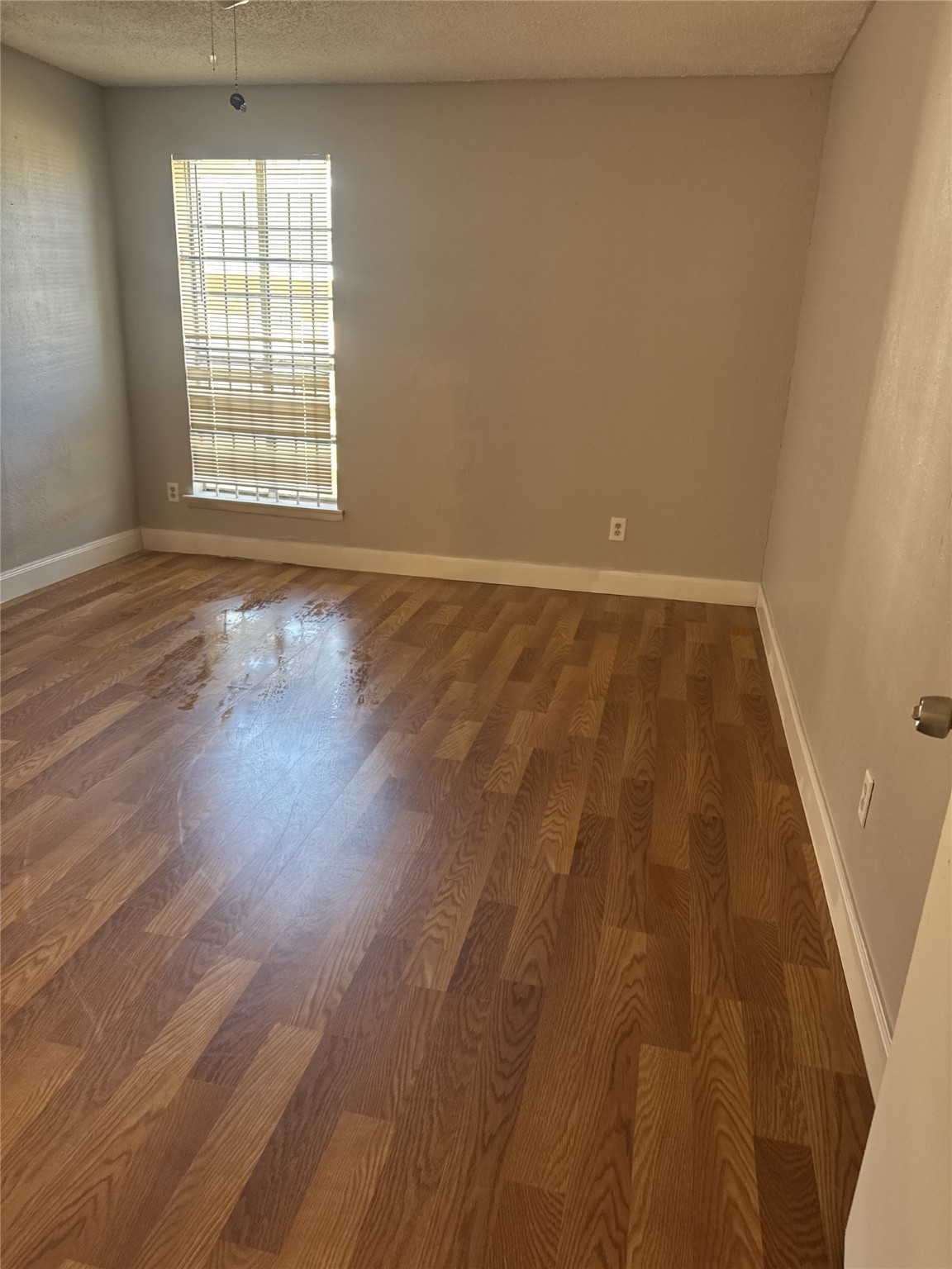 9537 Braeburn Glen Boulevard Houston, TX 77074 - Photo 4 of 15 wooden floor in an empty room with a window