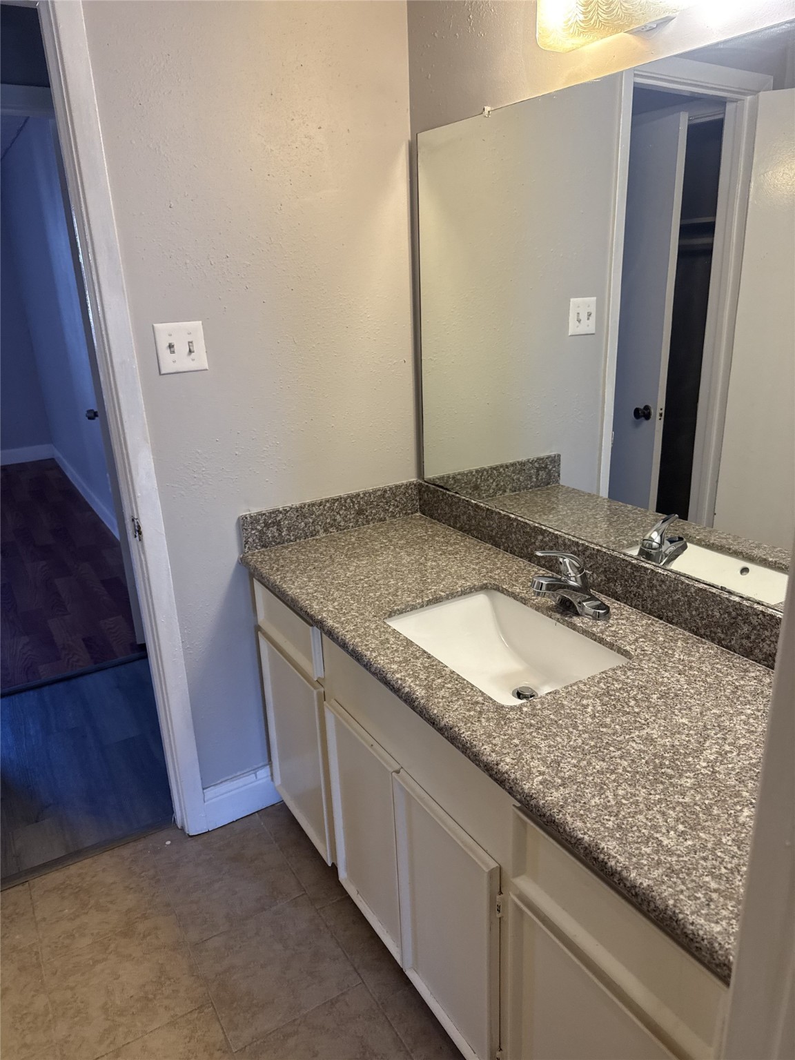 9537 Braeburn Glen Boulevard Houston, TX 77074 - Photo 5 of 15 a bathroom with a granite countertop sink and a mirror