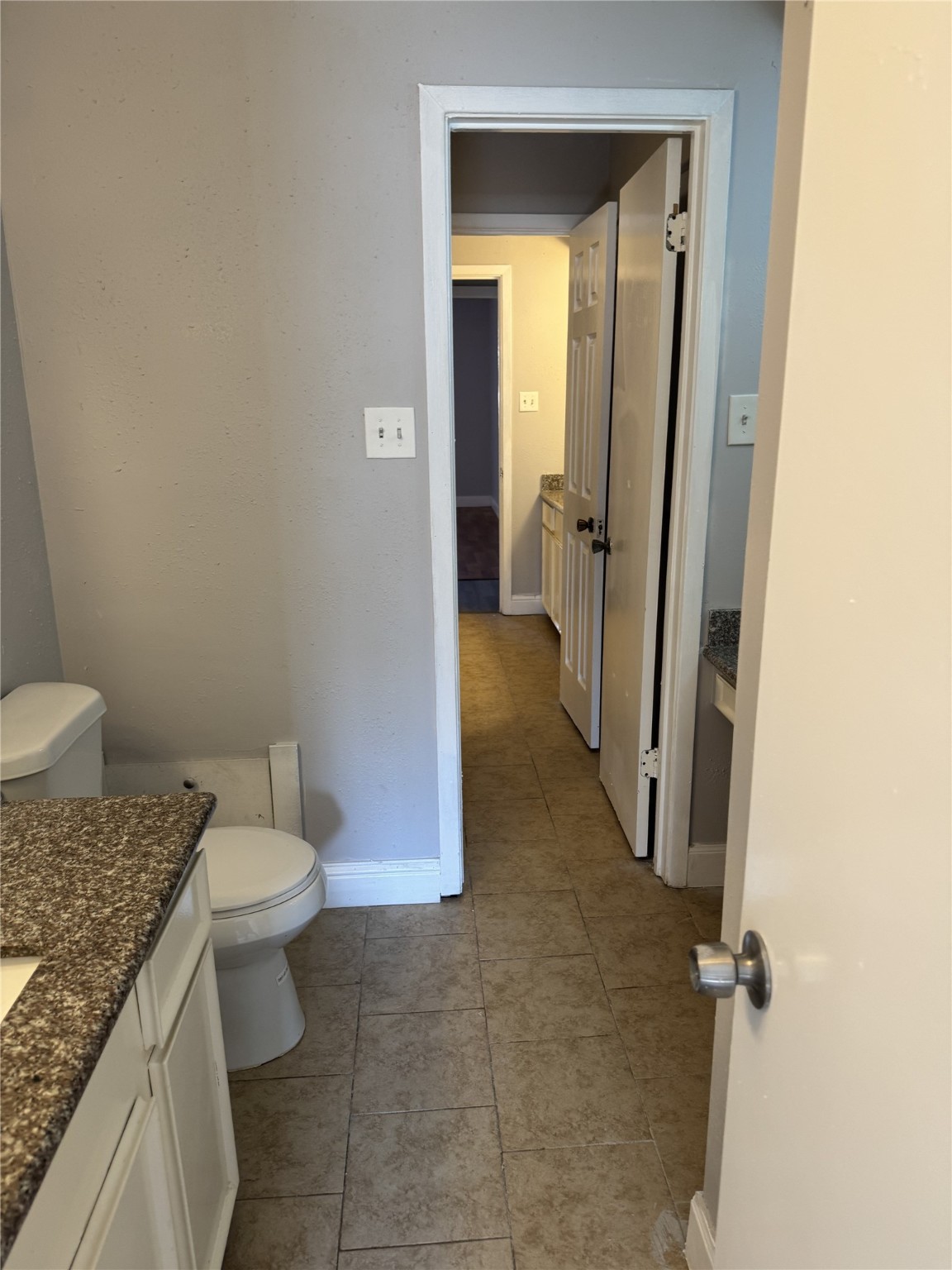 9537 Braeburn Glen Boulevard Houston, TX 77074 - Photo 7 of 15 a bathroom with a granite countertop sink and a toilet