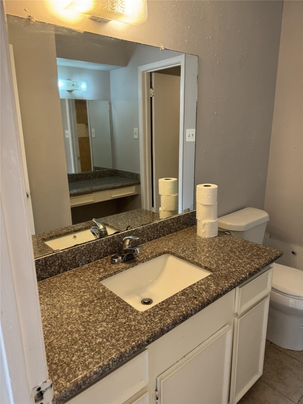 9537 Braeburn Glen Boulevard Houston, TX 77074 - Photo 8 of 15 a bathroom with a granite countertop sink and a mirror