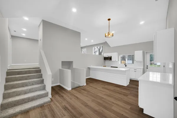 a view of kitchen with sink microwave and cabinets