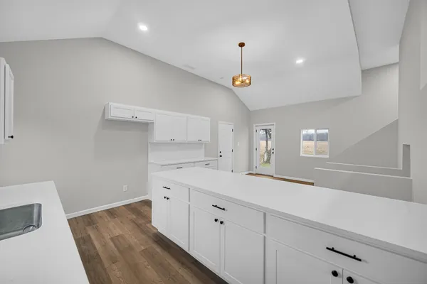 a kitchen with a sink and a stove top oven