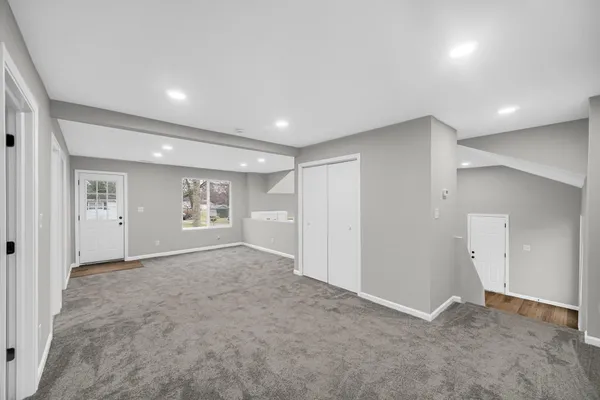 an empty room with windows and closet