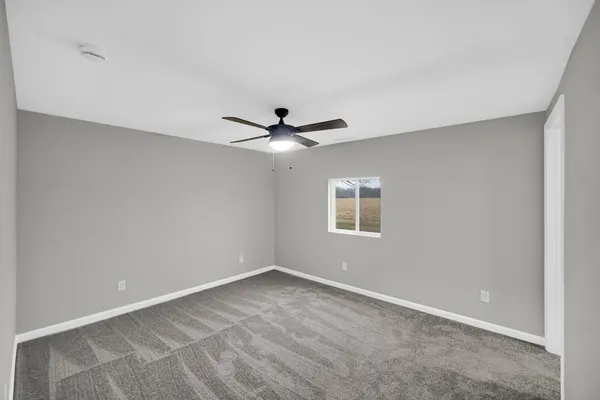 a view of room with a ceiling fan and window