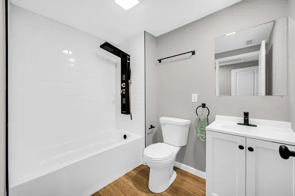 a bathroom with a sink toilet and shower