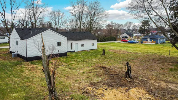 a view of a house with a yard and garage