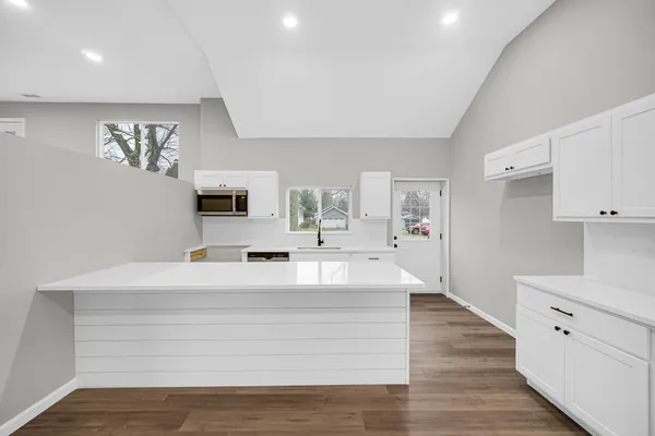 a view of living room with granite countertop furniture and flat screen tv