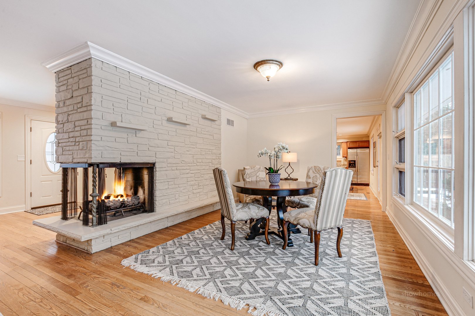 485 East Westleigh Road Lake Forest, IL 60045 - Photo 5 of 22 a dining room with a wooden floor and a fireplace