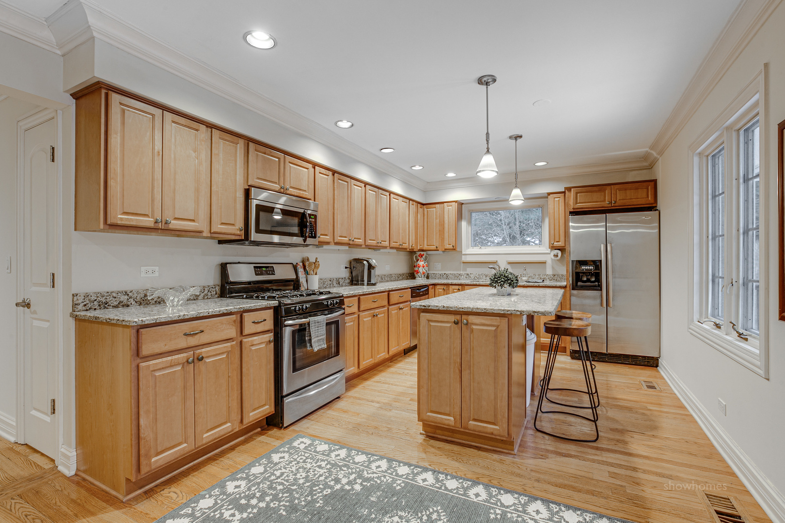 485 East Westleigh Road Lake Forest, IL 60045 - Photo 7 of 22 a kitchen with stainless steel appliances granite countertop a stove top oven a sink dishwasher and a refrigerator with wooden floor