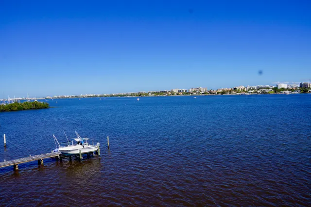 a view of a lake with table and chairs