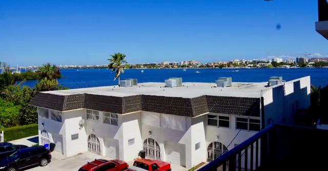 a view of a balcony with furniture and a potted plant