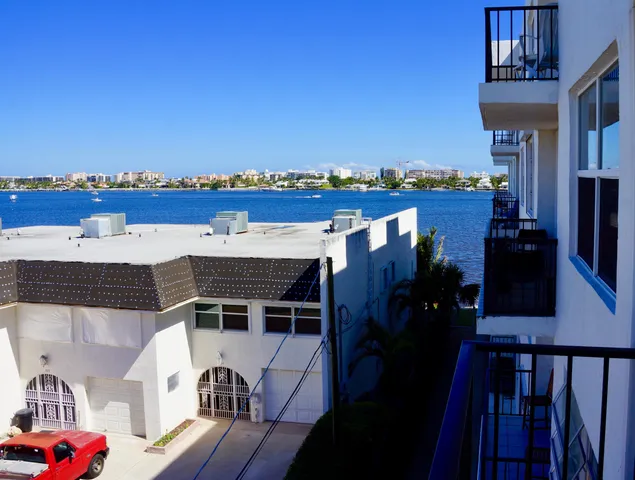 a view of a balcony with furniture and city view