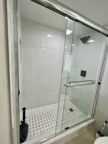 a bathroom with a shower and toilet