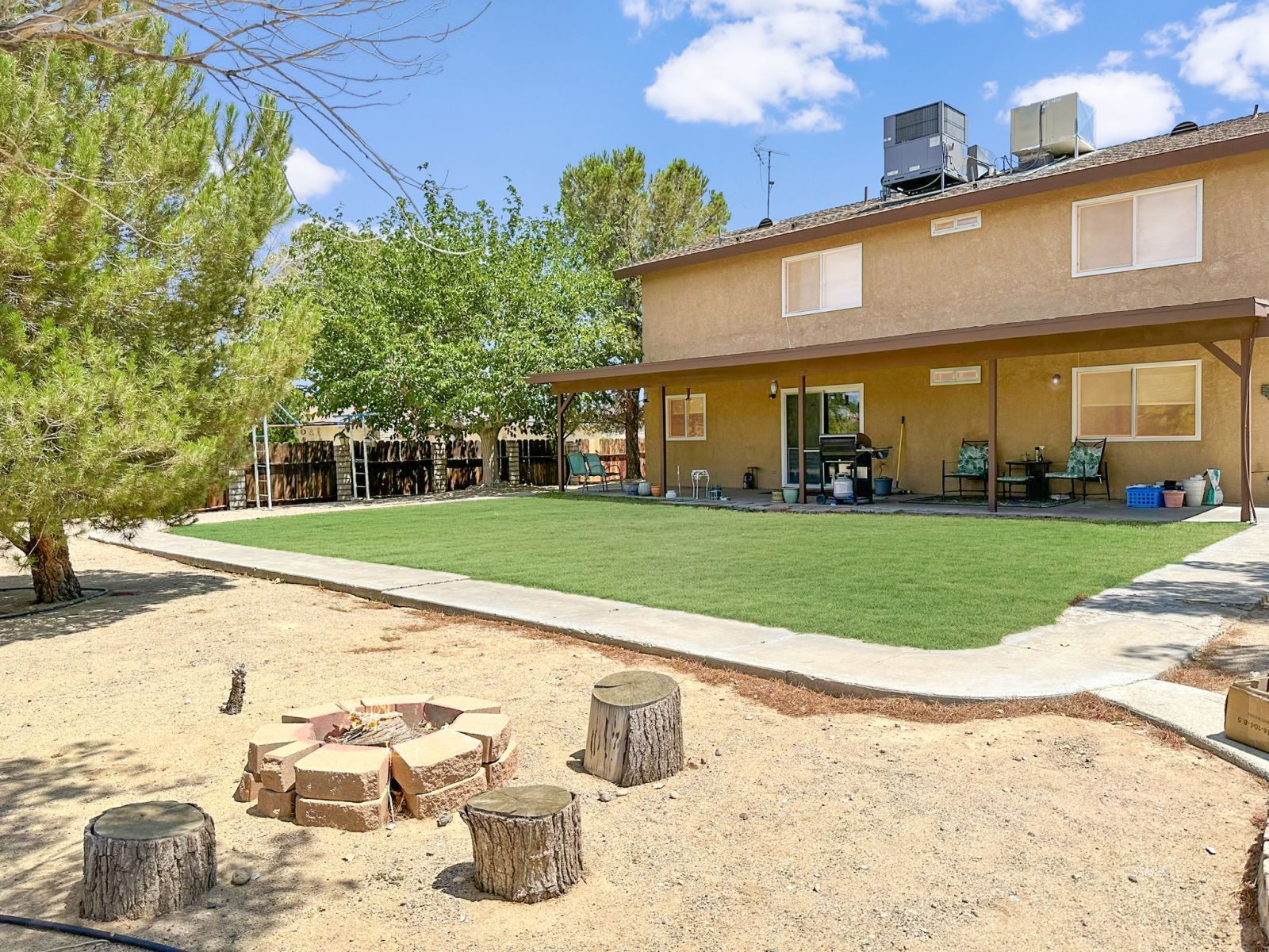 724 West Dolphin Avenue Ridgecrest, CA 93555 - Photo 43 of 50 a view of a white house with a yard