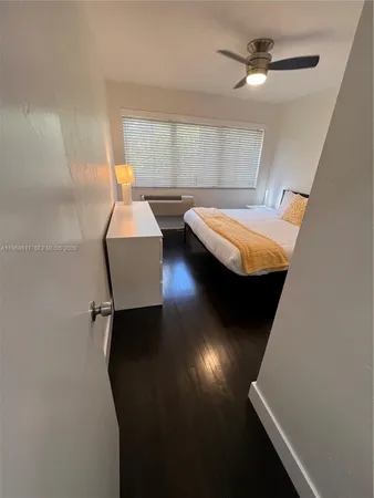 a view of a room with wooden floor and window