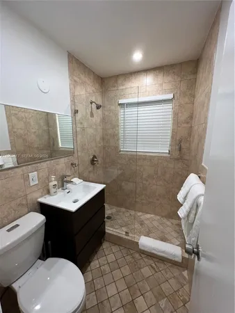 a bathroom with a sink toilet and mirror