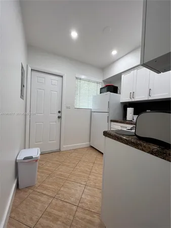 a view of a kitchen with granite countertop cabinets