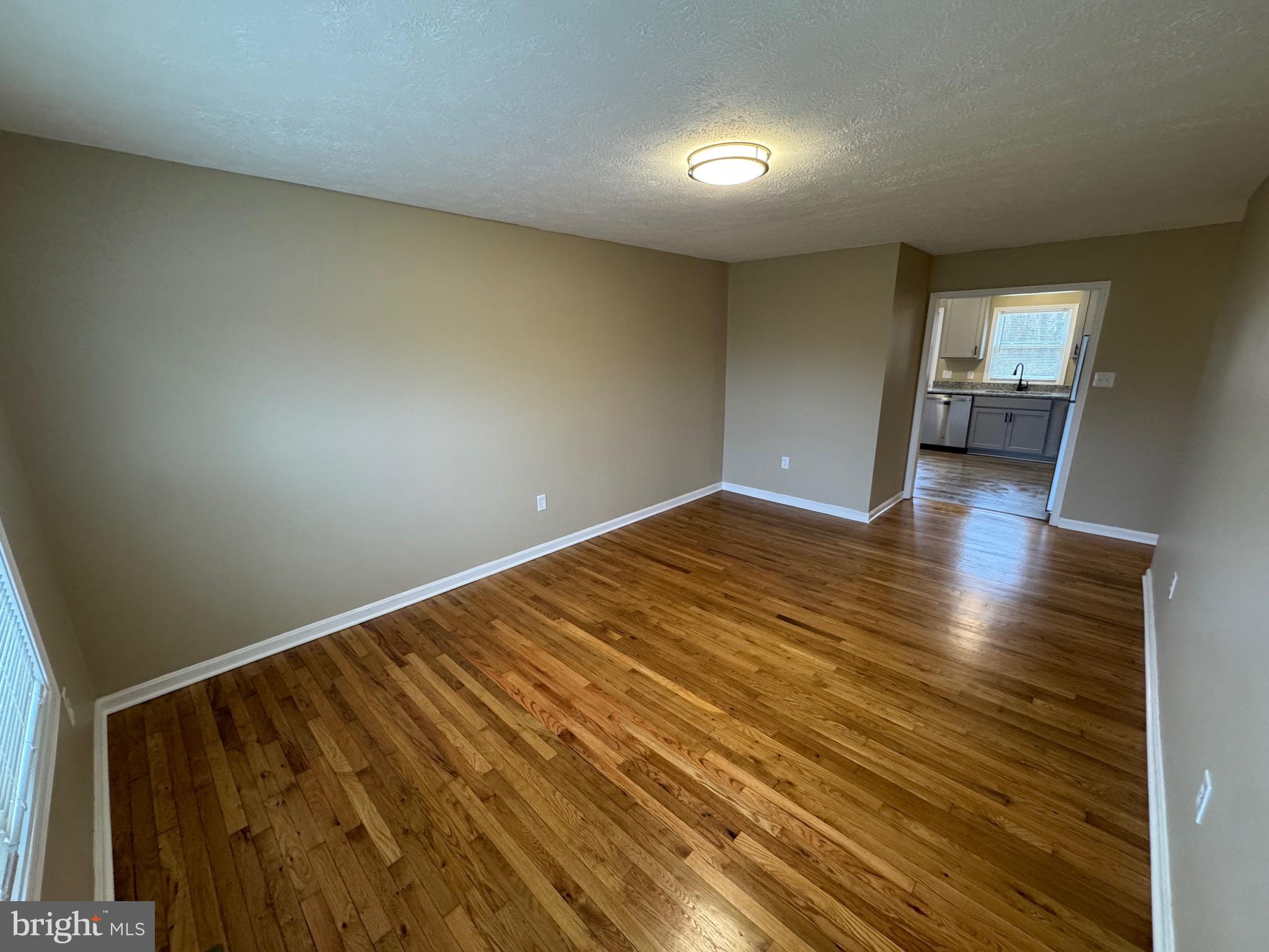 127 Longstreet Avenue Winchester, VA 22603 - Photo 2 of 18 a view of empty room with wooden floor