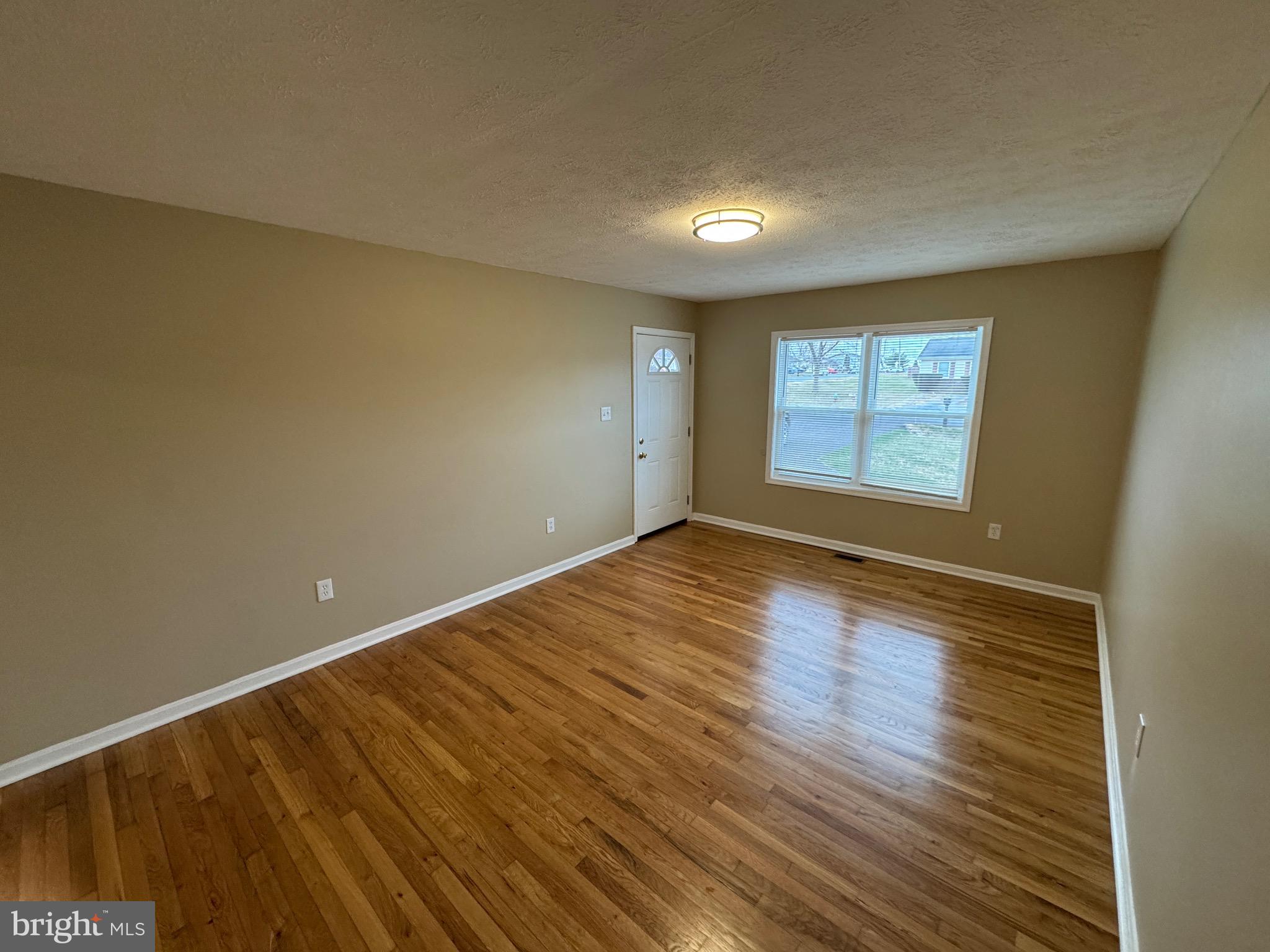 127 Longstreet Avenue Winchester, VA 22603 - Photo 3 of 18 a view of empty room with wooden floor and fan