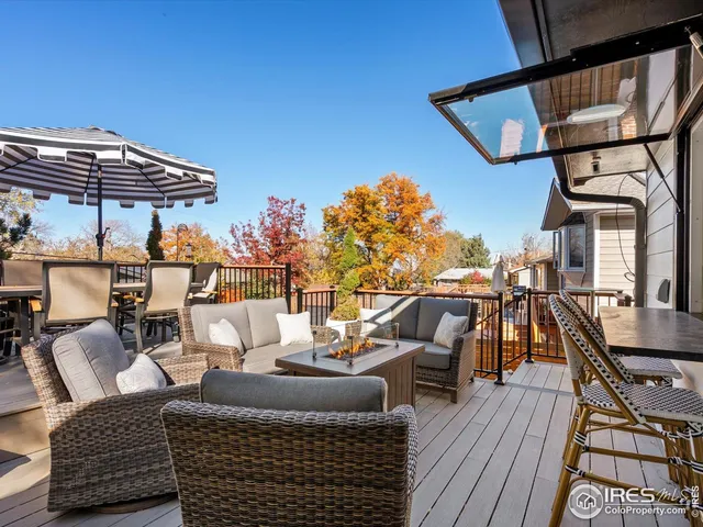 a view of outdoor sitting area with furniture and wooden floor