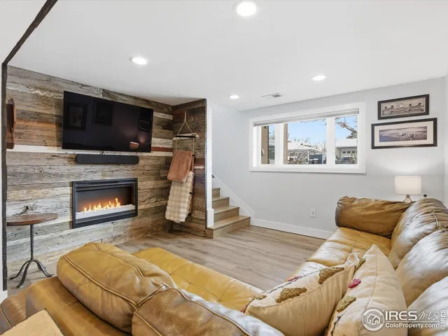 a living room with a couch a flat screen tv and a fireplace