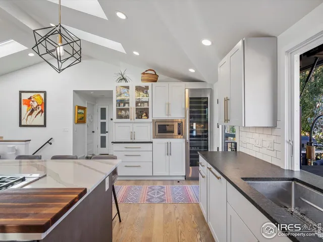 a kitchen with stainless steel appliances granite countertop a sink and stove