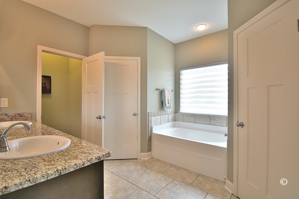 7 Eagle Ridge Lane Fort Mitchell, AL 36856 - Photo 14 of 24 a bathroom with a granite countertop sink and a bathtub