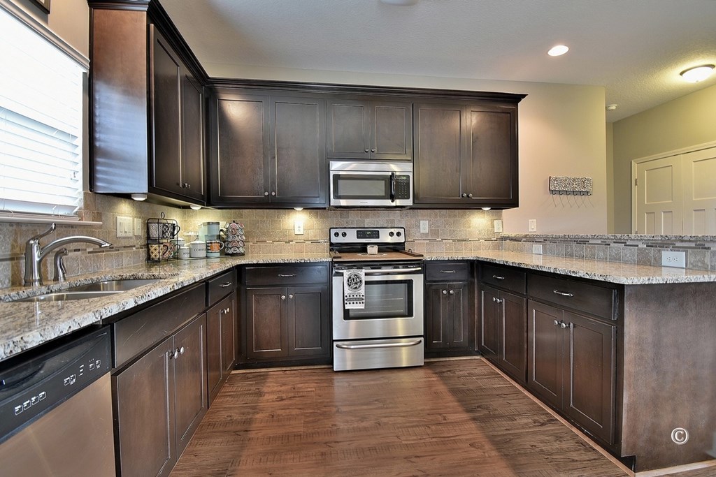 7 Eagle Ridge Lane Fort Mitchell, AL 36856 - Photo 9 of 24 a kitchen with granite countertop a sink and cabinets