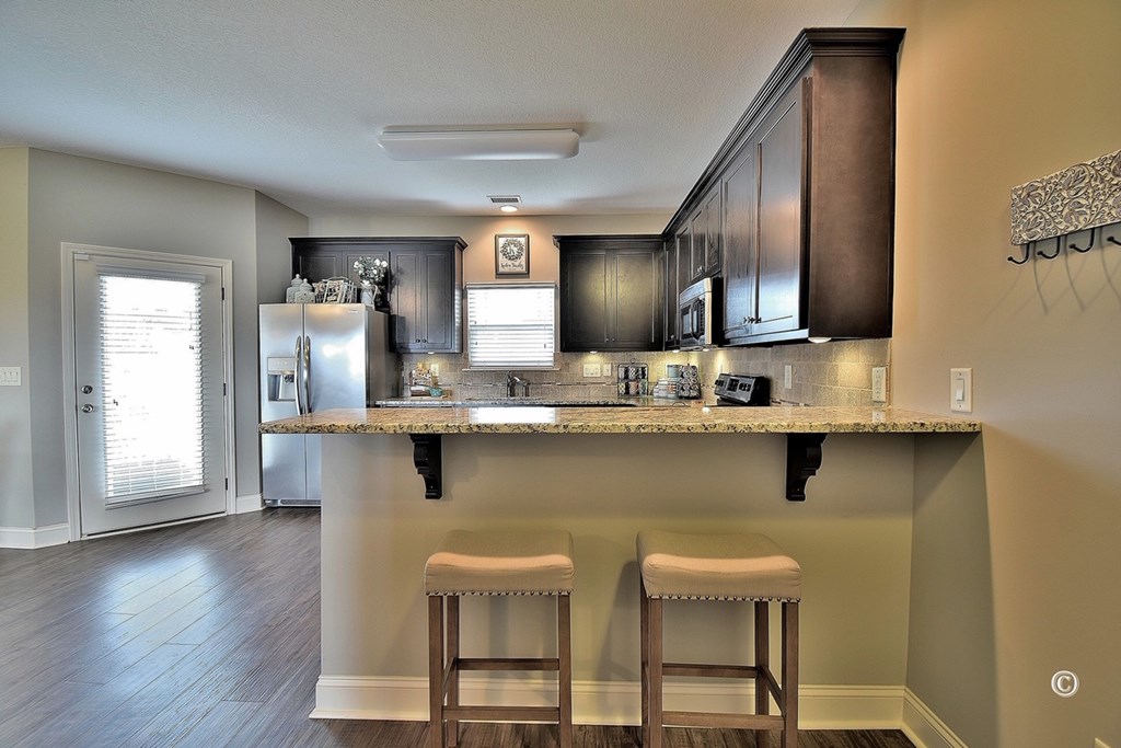 7 Eagle Ridge Lane Fort Mitchell, AL 36856 - Photo 10 of 24 a kitchen with stainless steel appliances granite countertop a sink table and chairs