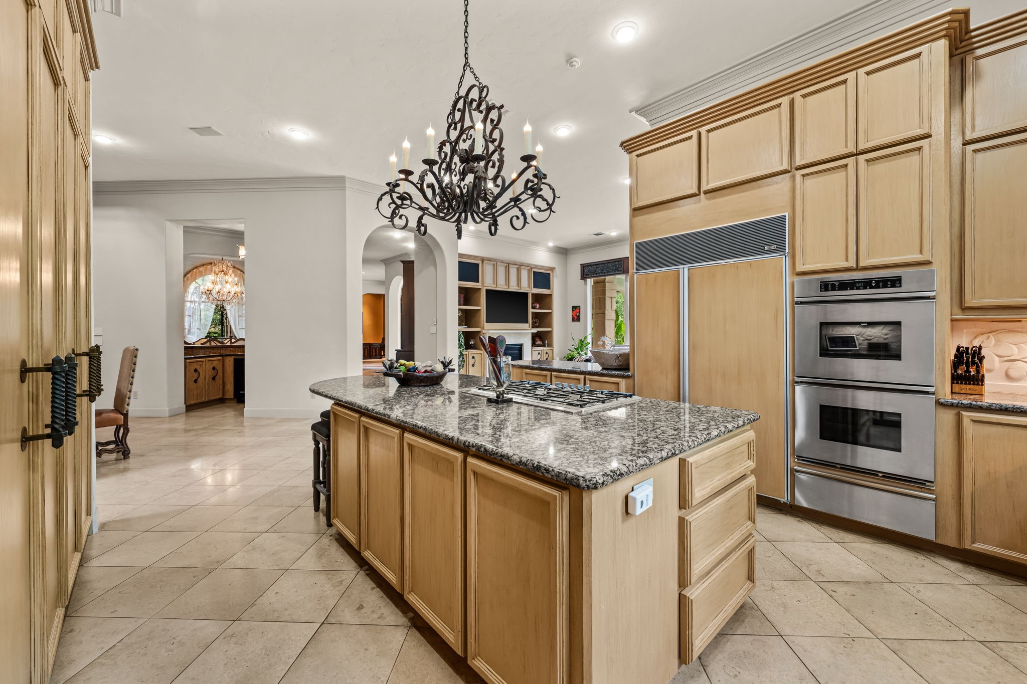 6 Mott Lane Houston, TX 77024 - Photo 29 of 50 Large center island with cooktop, double ovens and warming drawer that open to adjacent living areas.
