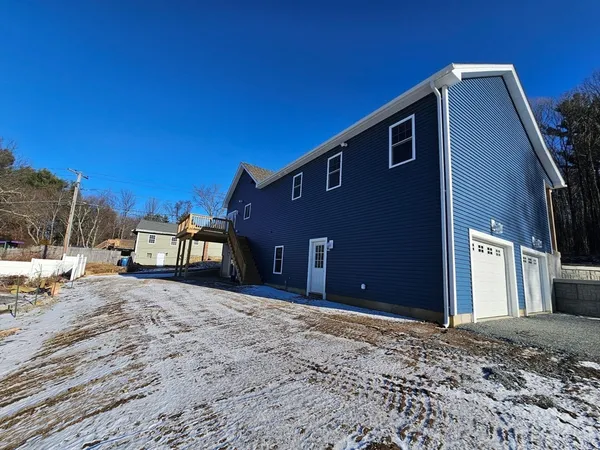 a view of a house with a snow in the yard