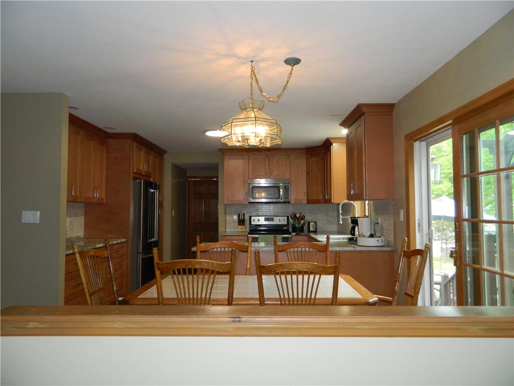 328 Pin Oak Road Stroudsburg, PA 18360 - Photo 15 of 37 A warm kitchen with wooden cabinetry provides ample space for daily meals.