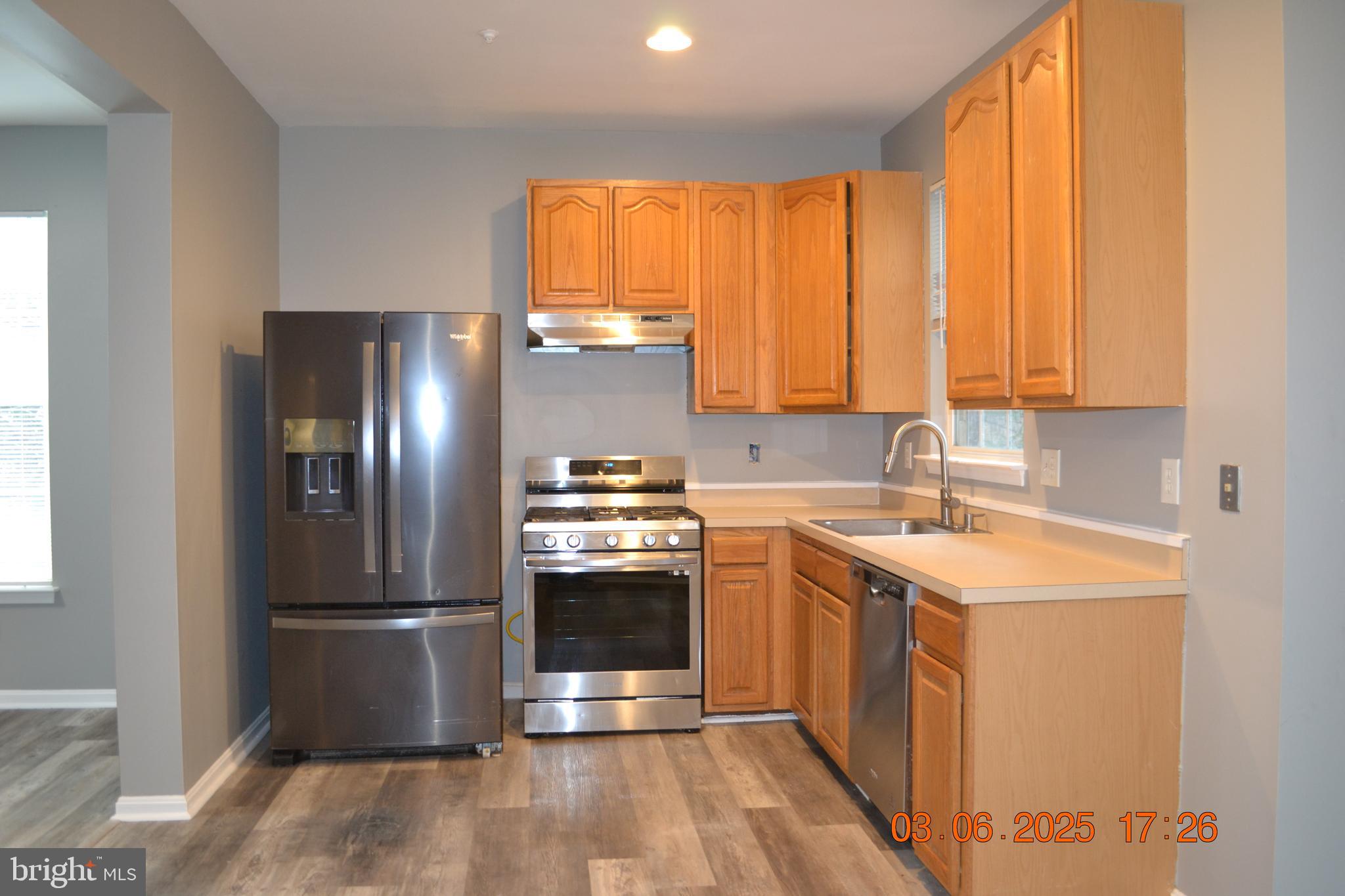 1302 Hill Born Drive Hanover, MD 21076 - Photo 7 of 31 a kitchen with stainless steel appliances granite countertop a refrigerator a sink and a stove