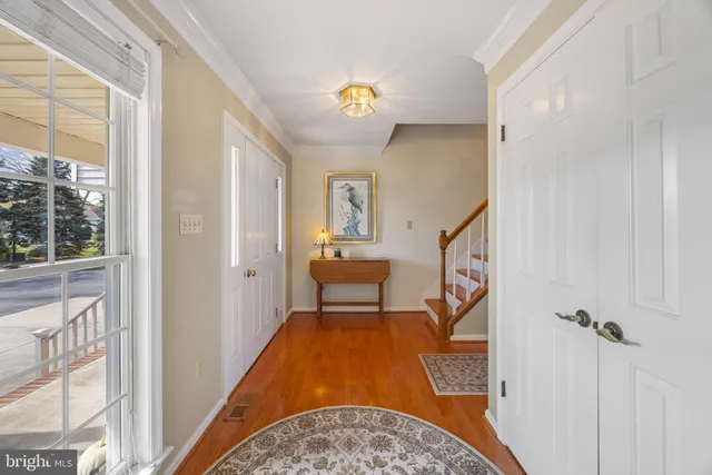 a large kitchen with kitchen island a large window and stainless steel appliances