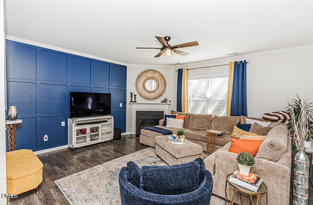 3425 Teravista Way Raleigh, NC 27616 - Photo 12 of 49 a living room with furniture a flat screen tv and a fireplace
