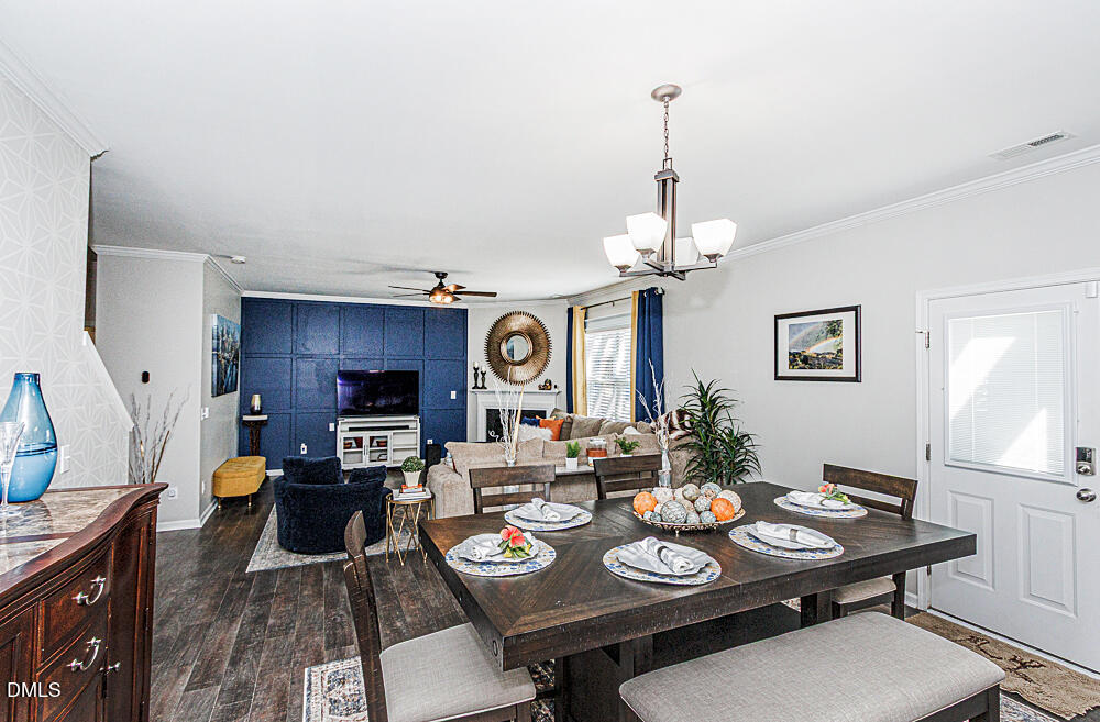 3425 Teravista Way Raleigh, NC 27616 - Photo 14 of 49 a view of a dining room with furniture a chandelier and wooden floor