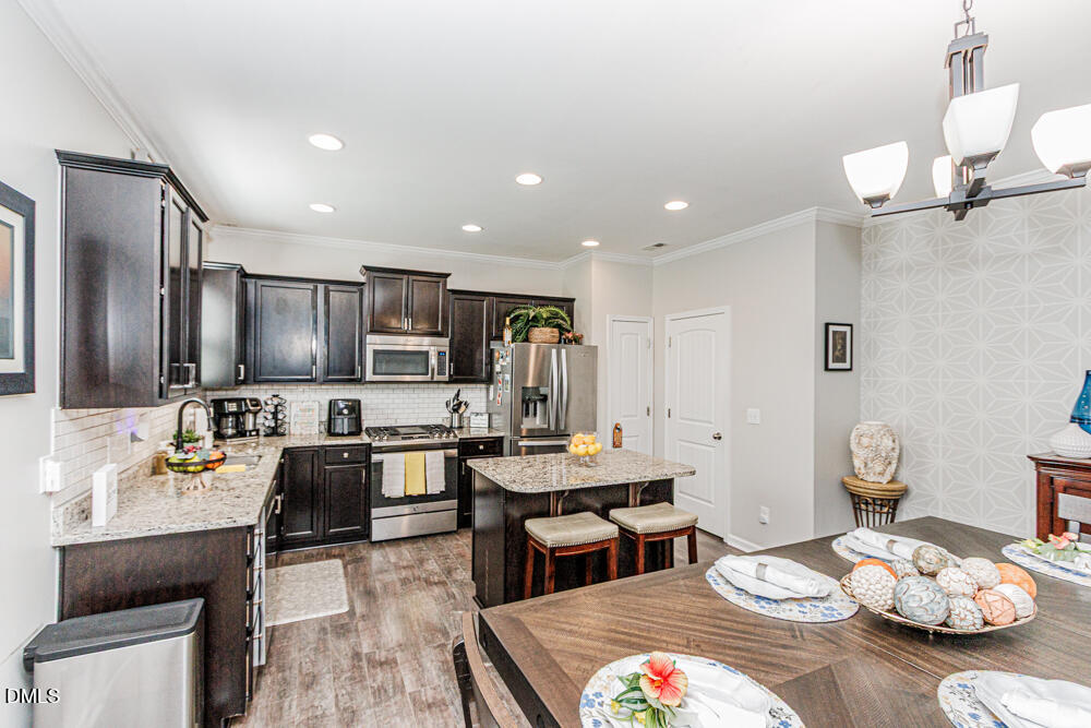 3425 Teravista Way Raleigh, NC 27616 - Photo 18 of 49 a large kitchen with a table and chairs in it