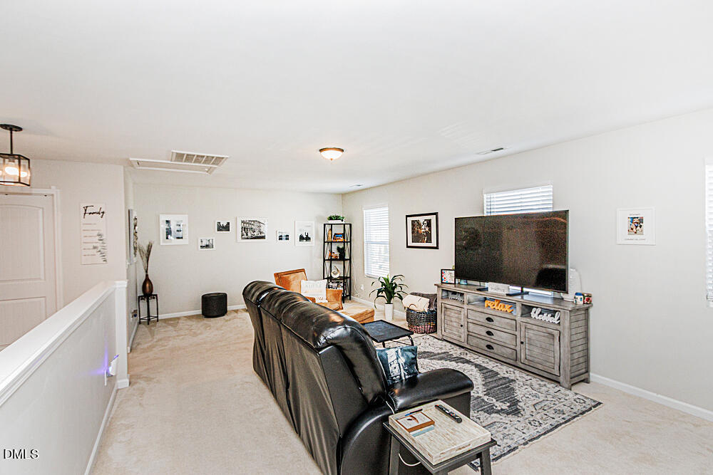 3425 Teravista Way Raleigh, NC 27616 - Photo 22 of 49 a living room with furniture and a flat screen tv