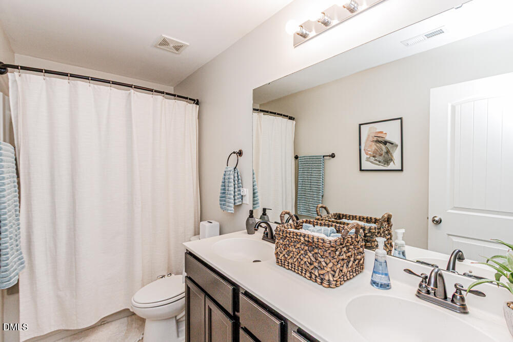 3425 Teravista Way Raleigh, NC 27616 - Photo 23 of 49 a bathroom with a sink and a mirror