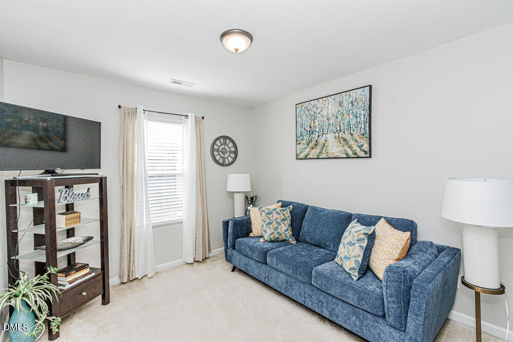 3425 Teravista Way Raleigh, NC 27616 - Photo 25 of 49 a living room with furniture and a flat screen tv
